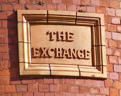 Stone sign at the top of Exchange Bdg